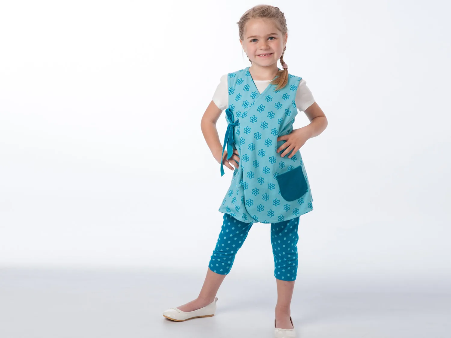 Lined baby tunic wrap dress pattern for girls. Easy sewing reversible dress with or without sleeves. Paper pattern MARIE by Patternforkids