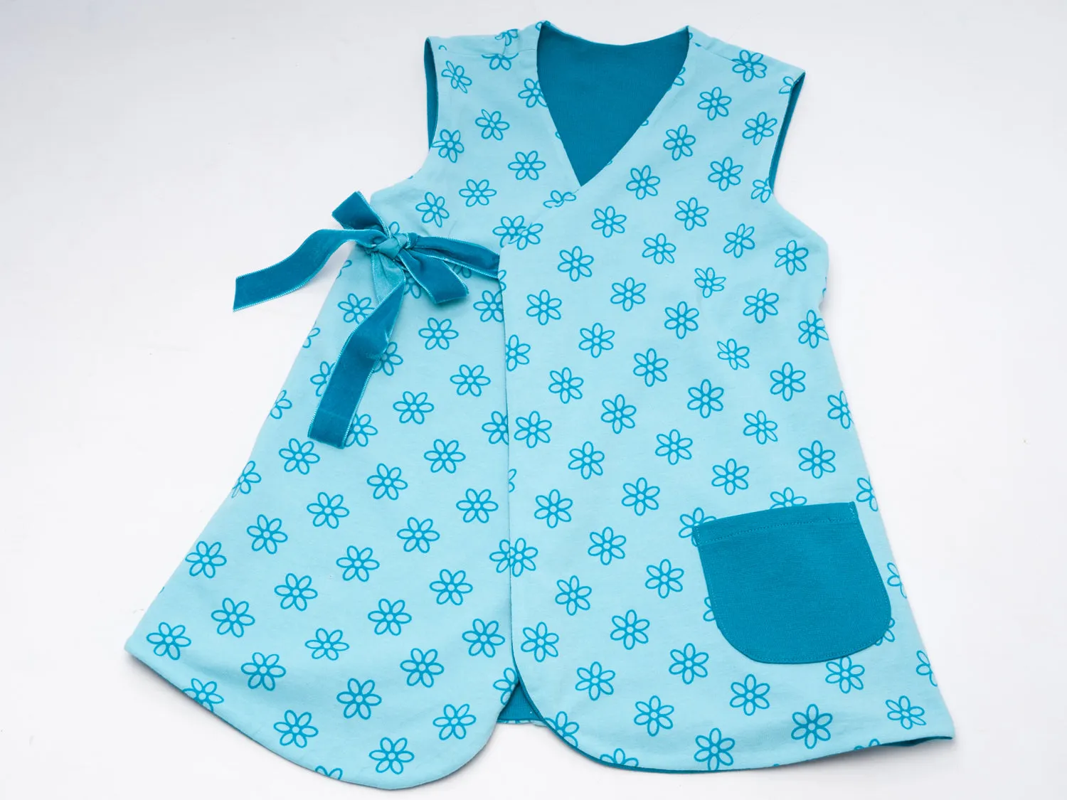 Lined baby tunic wrap dress pattern for girls. Easy sewing reversible dress with or without sleeves. Paper pattern MARIE by Patternforkids